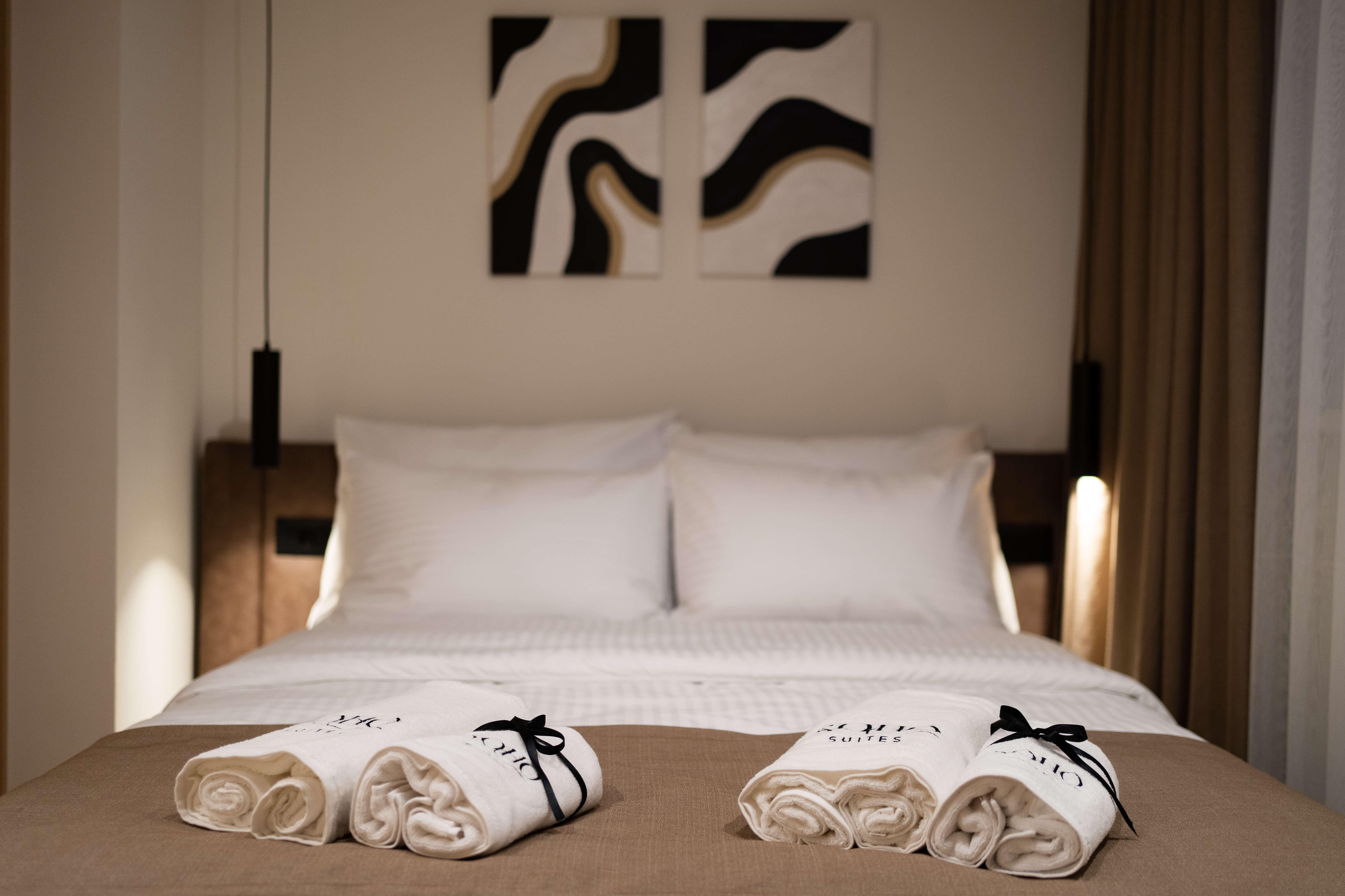 Soho Suites — calm, beige-toned bedroom with premium linen